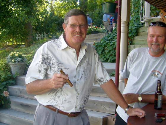 Tim gives Tom a cigar.  (Tom is glad he got invited)
